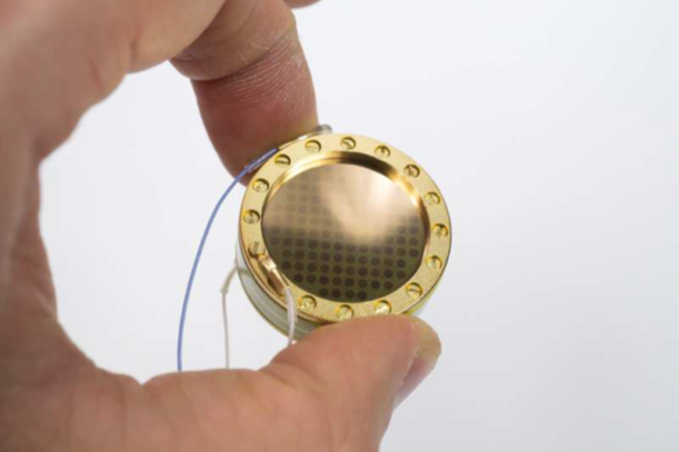 Capsule mounting screws being tightened to firm contact.